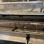 Drill core freshly cut in half using the Slabbing Saw 500, showing clean longitudinal section for geological examination.